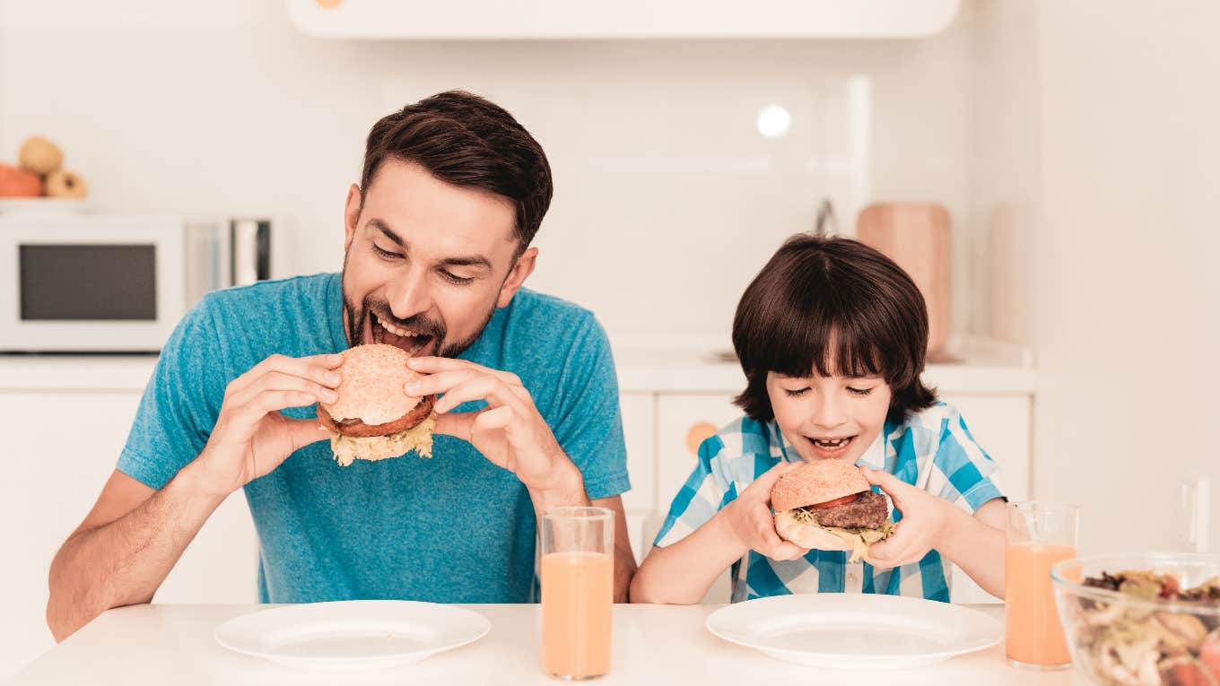 Husband eating meat with his kid