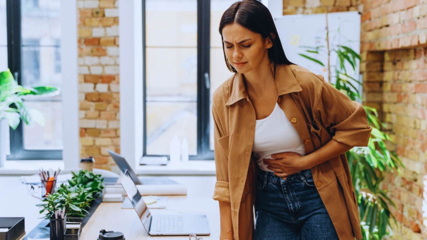 woman having cramps at work