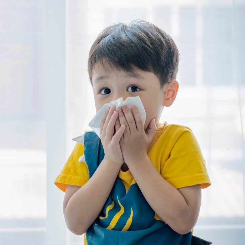 Little kid blowing nose