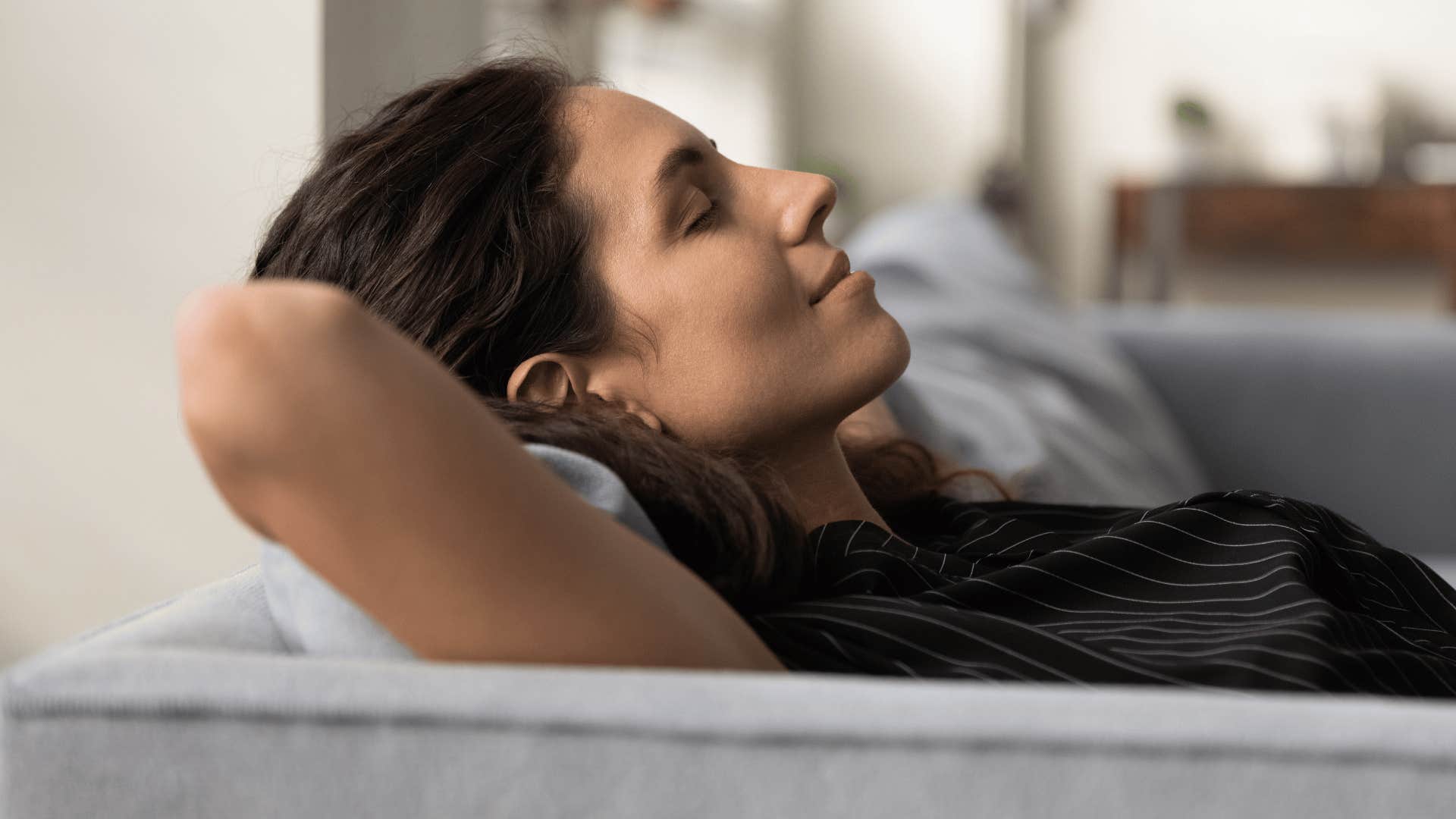 woman relaxing on her couch