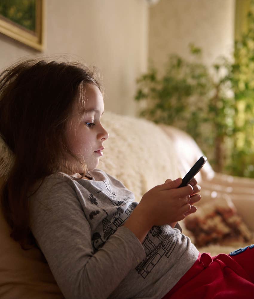 little girl absorbed by phone