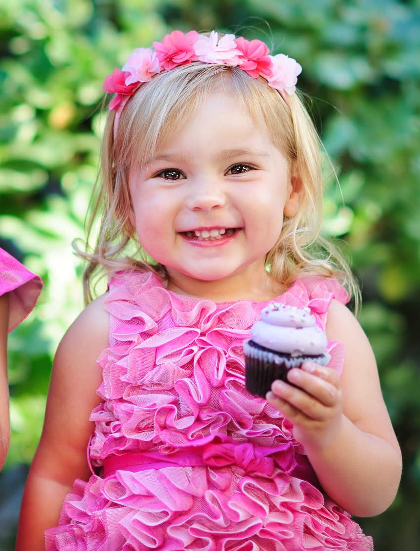 Toddler eating vegan cupcake