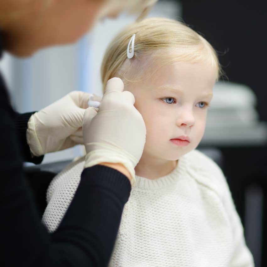 Little girl getting her ears pierced 