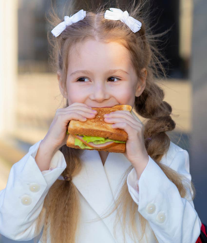 Little girl eating a sandwich