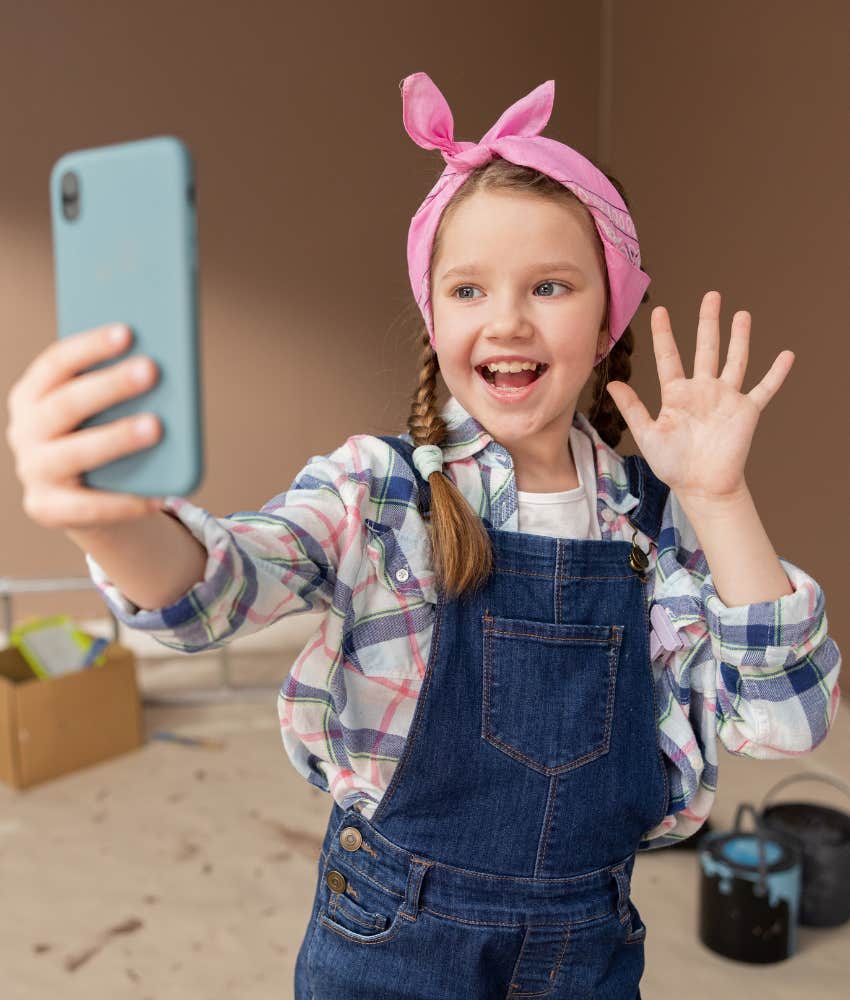 little girl filming a TikTok video