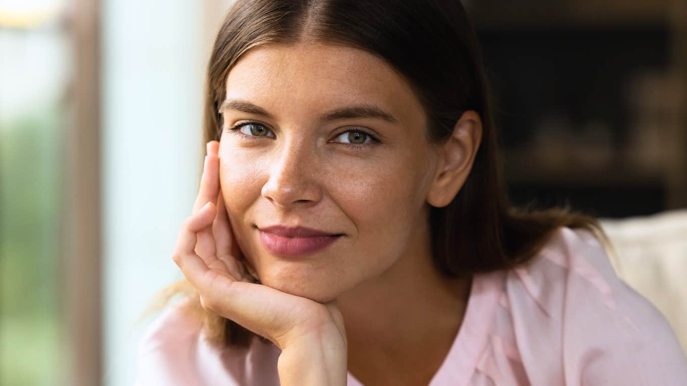 happy smiling woman with hand on chin