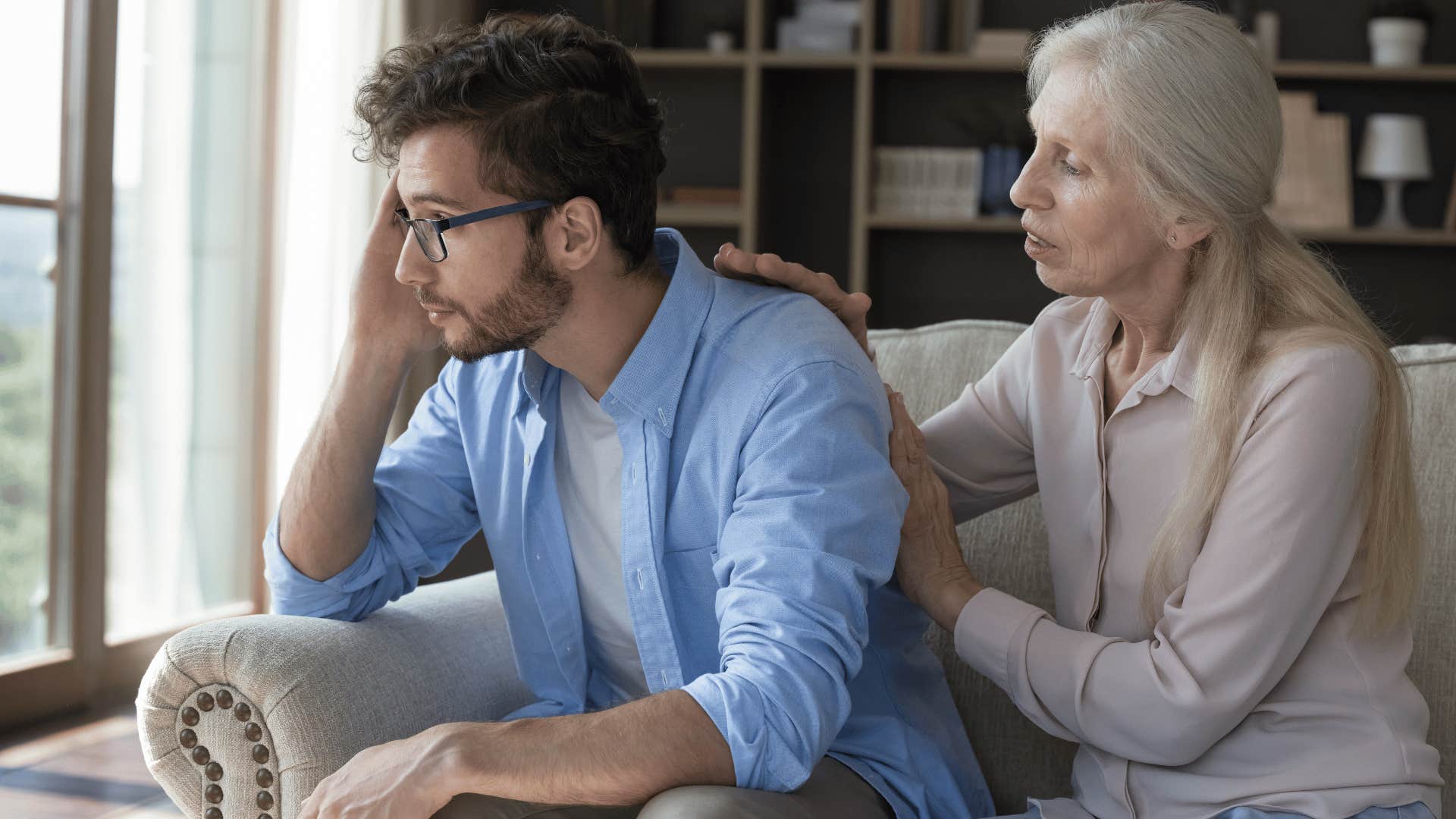 older woman comforting man 