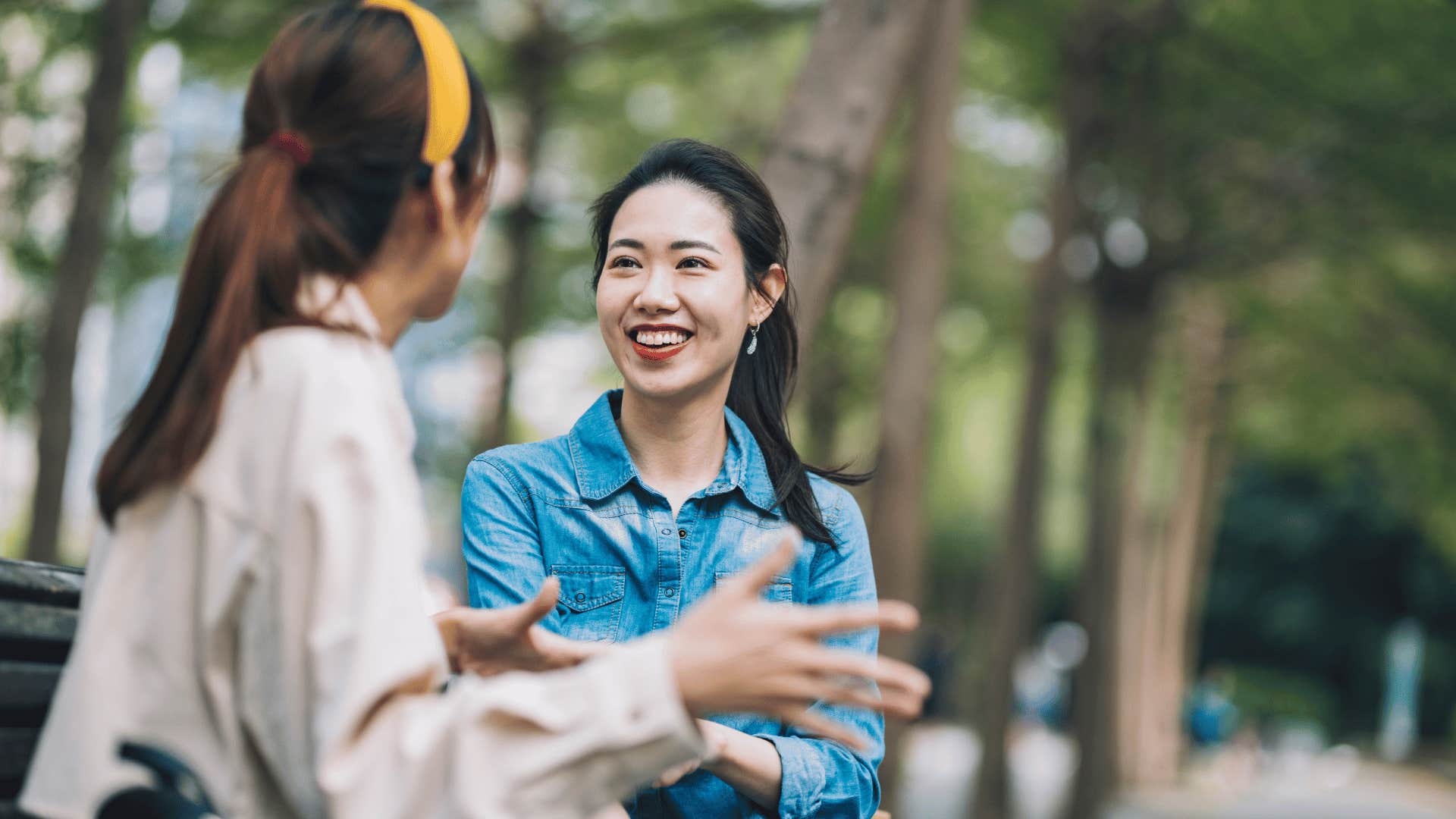 two women talking outside and smiling 