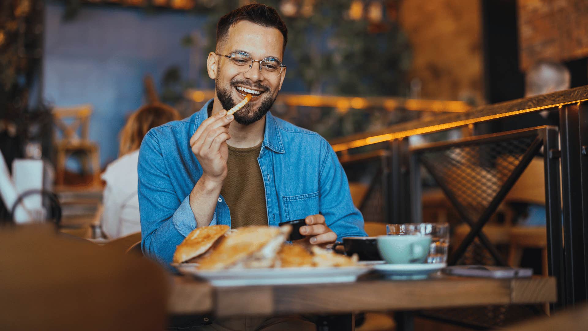 man eating food at restaurant 