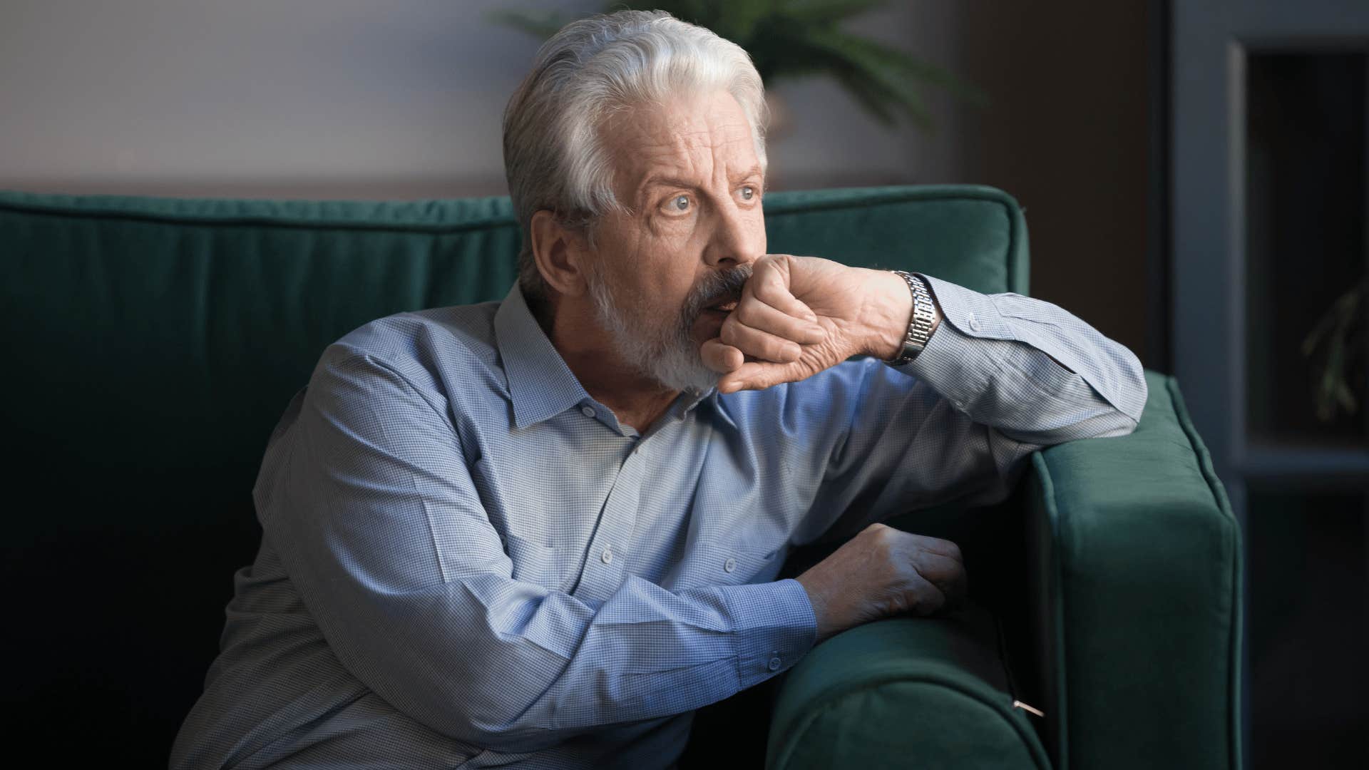 man reflecting on couch