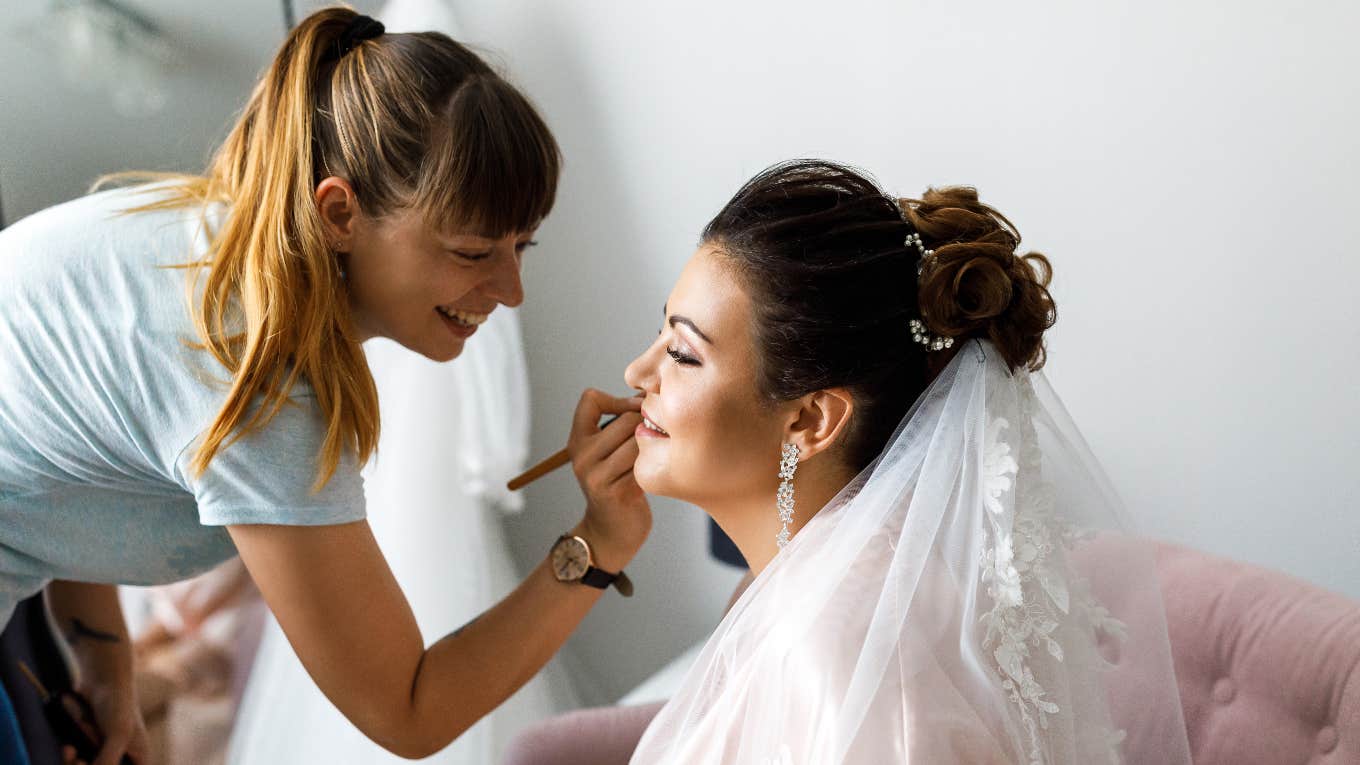 Wedding makeup artist and bride