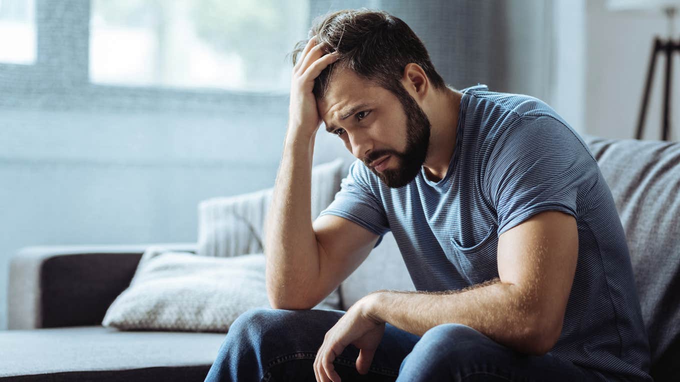 Man holding his head in pain both physically and emotionally