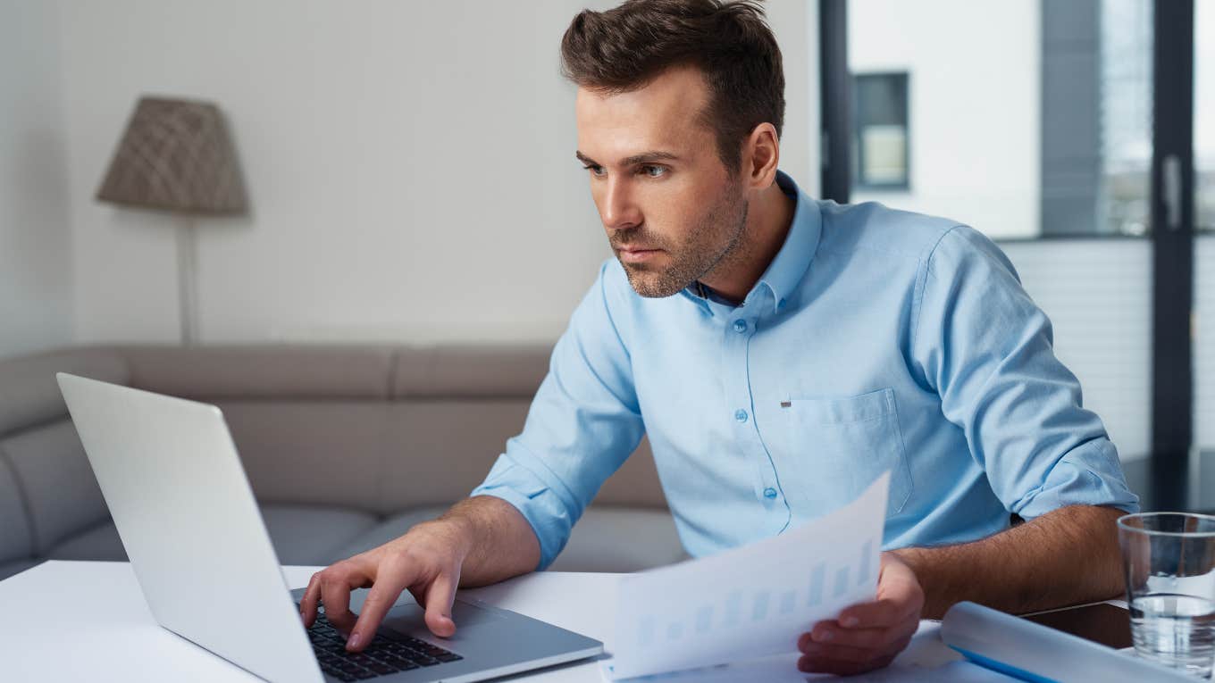 Young man at computer trying to budget and pay bills