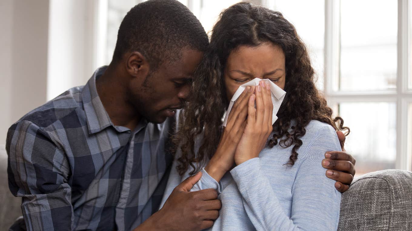 Man comforting his fiancée who is crying after a Taylor Swift song that reminded her of her late ex