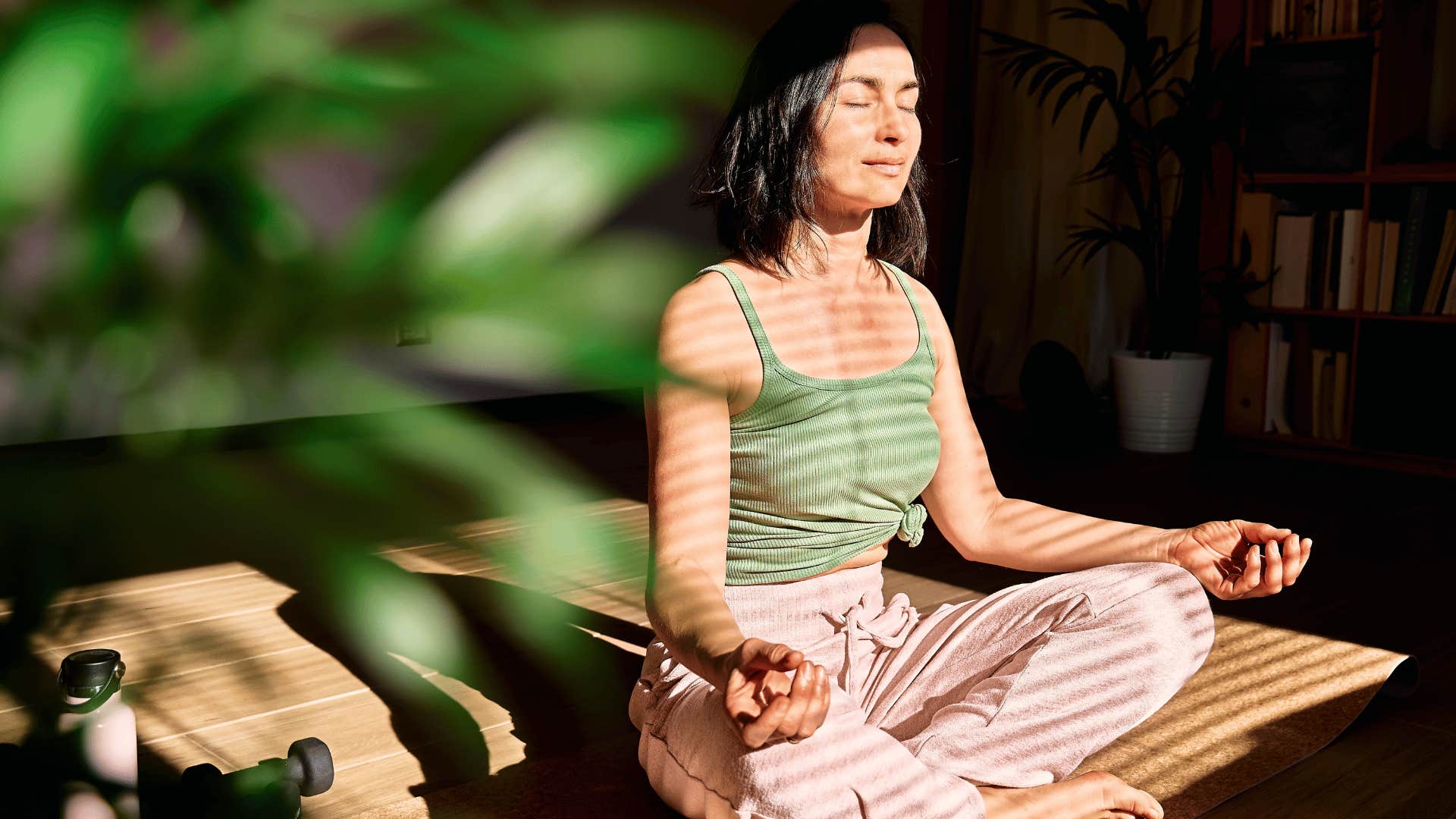 woman meditating on rug