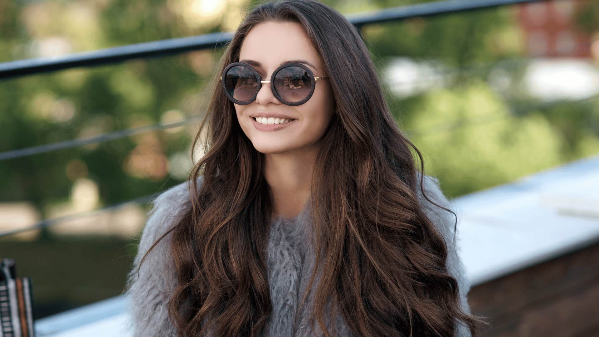 woman with sunglasses smiling 