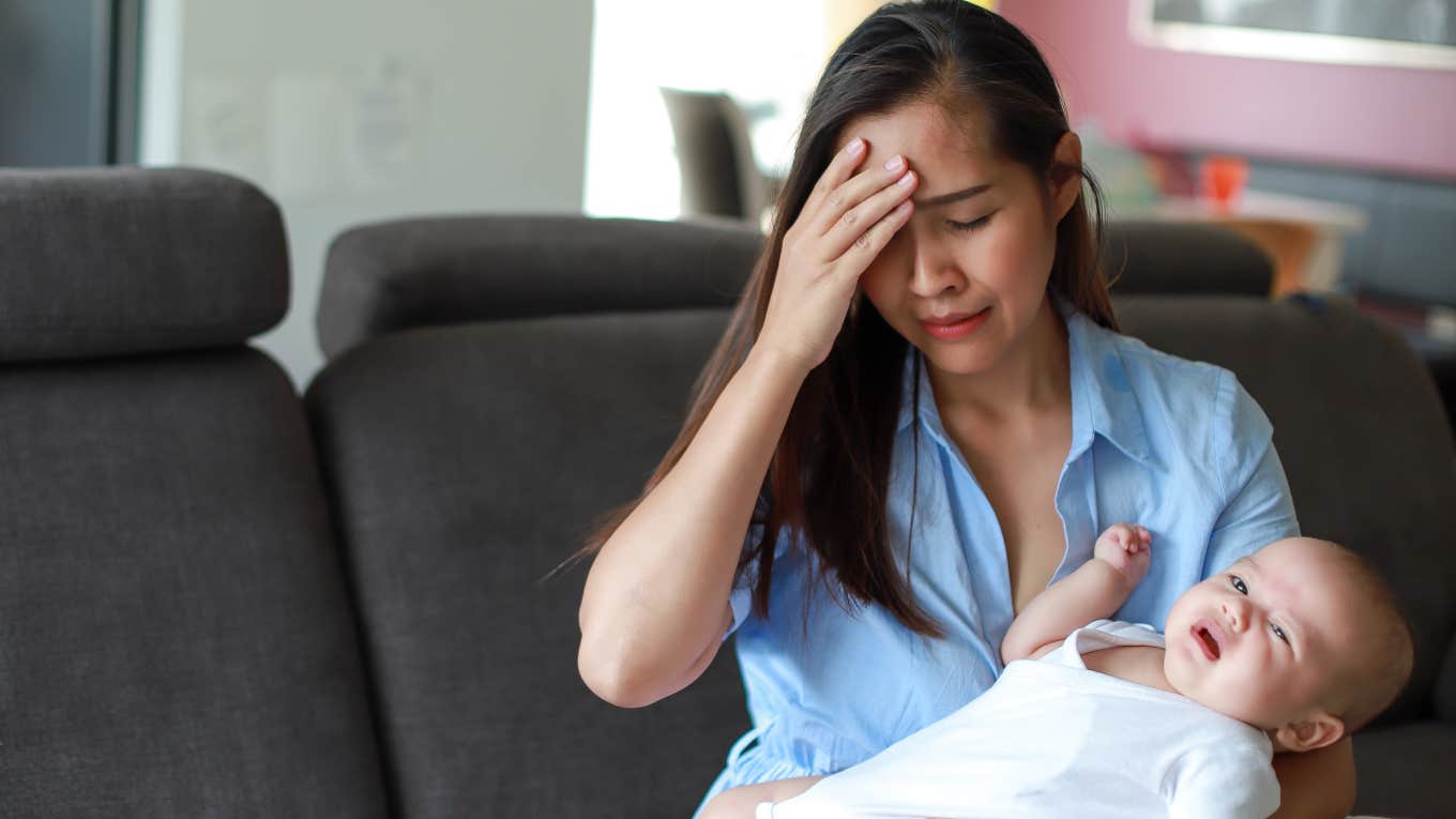 frustrated, upset mom holding crying baby