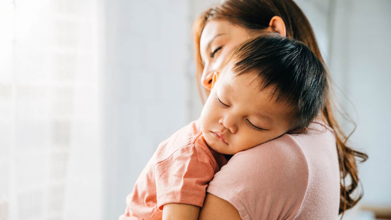 mom rocking baby to sleep 