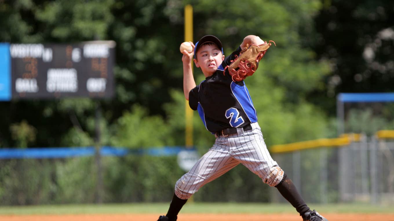 Little boy pitching baseball