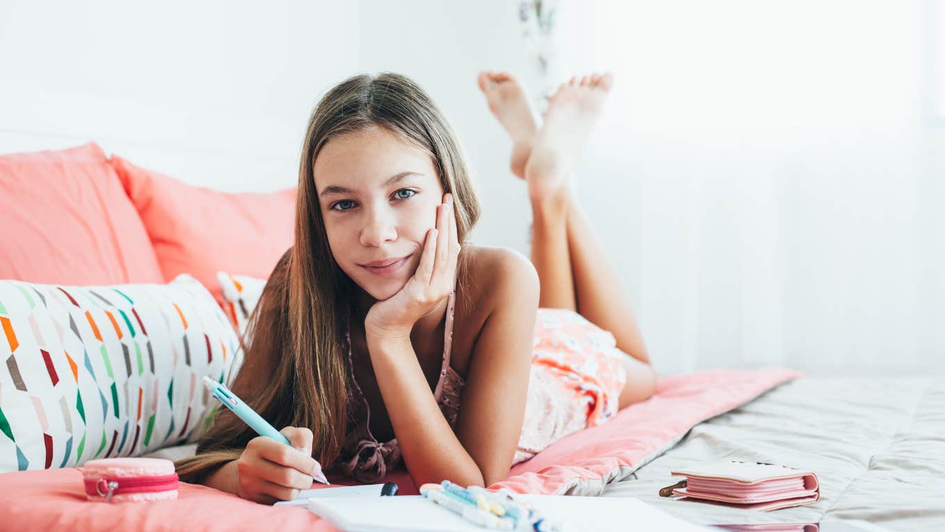 Tween girl sitting spending time alone in her bedroom