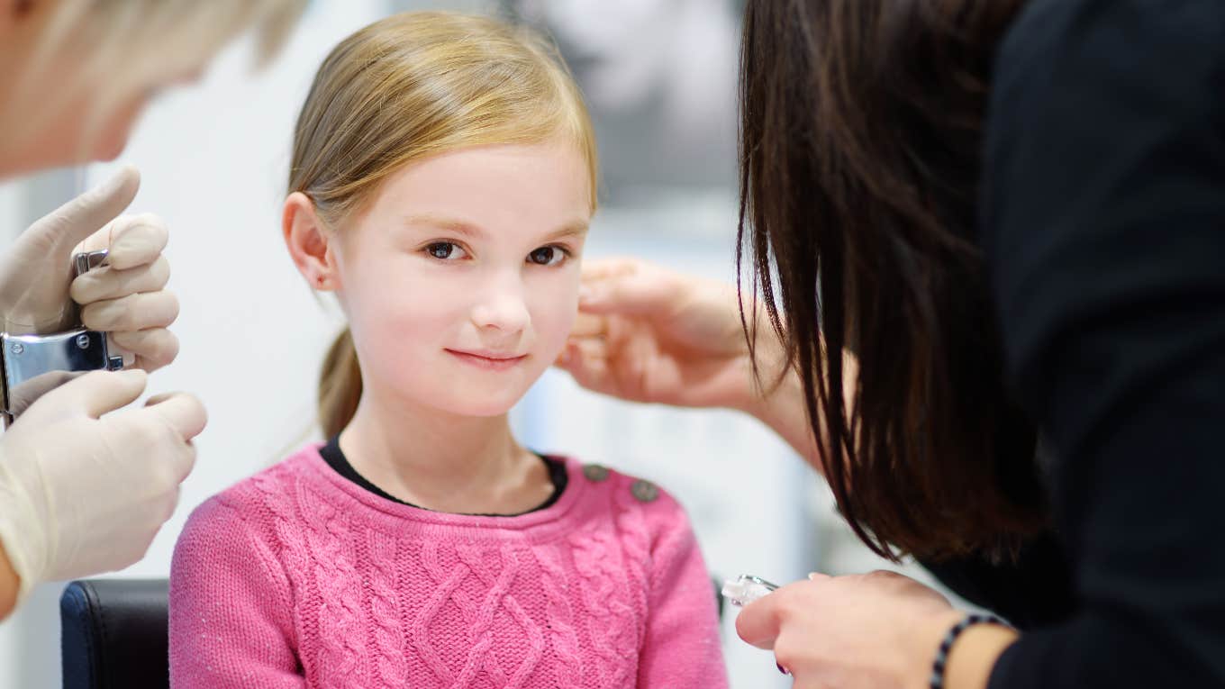 Daughter getting her ears pierced