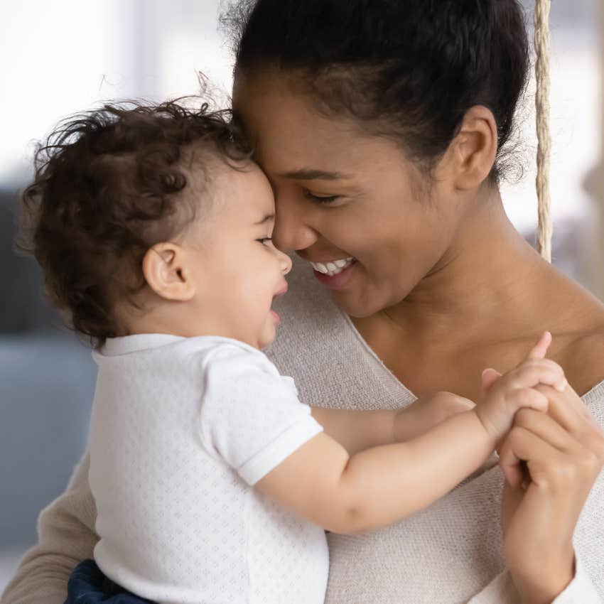 joyful woman holding her baby