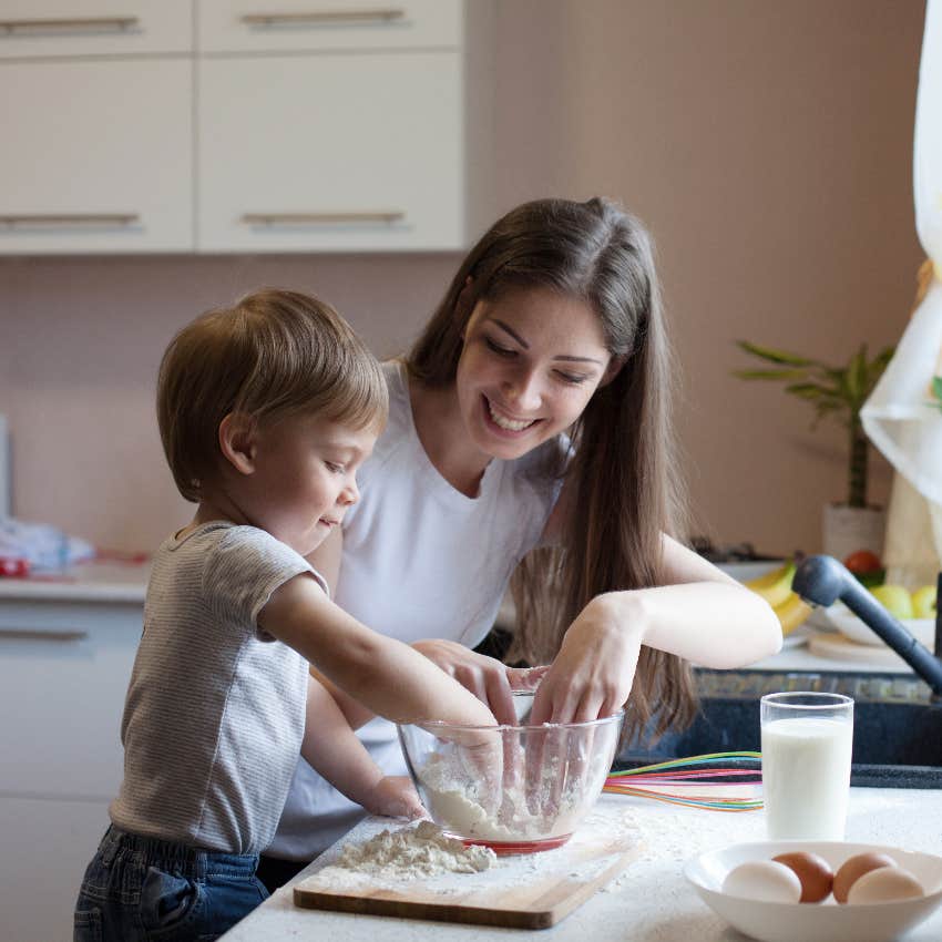 Working mom making potluck dish with her toddler