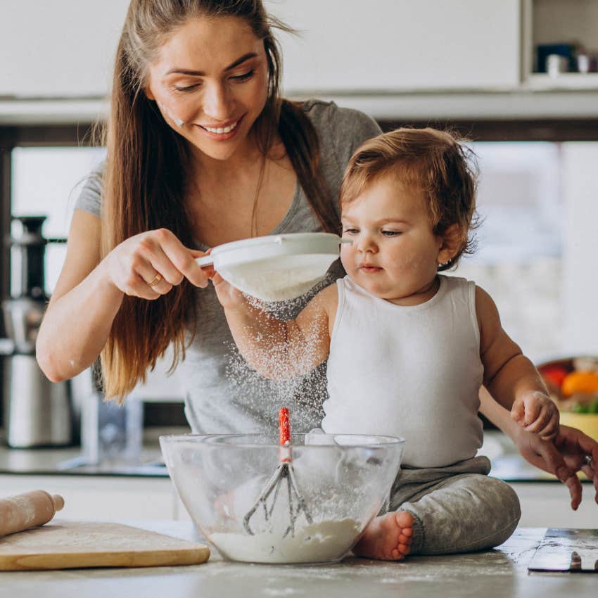 Working mom making potluck dish with her toddler