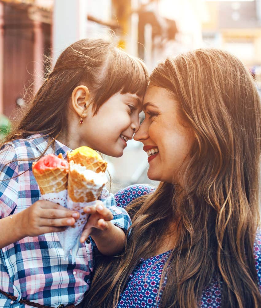 Mom and young daughter sharing ice cream