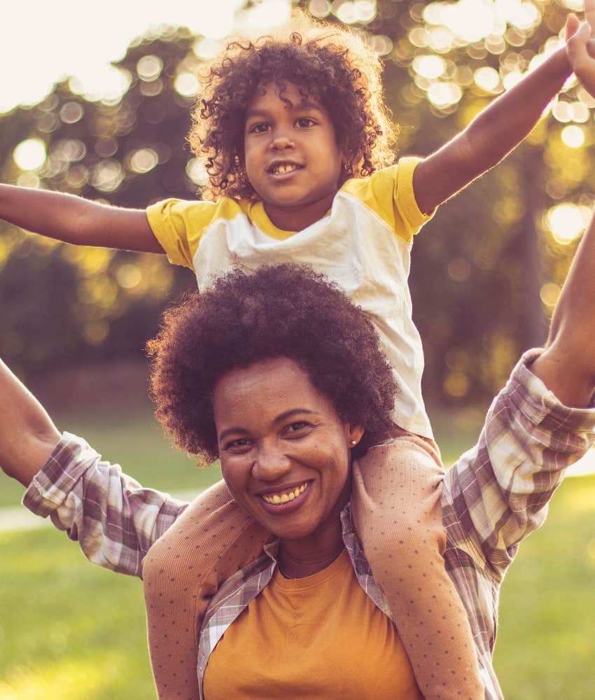 mom with son on her shoulders having fun