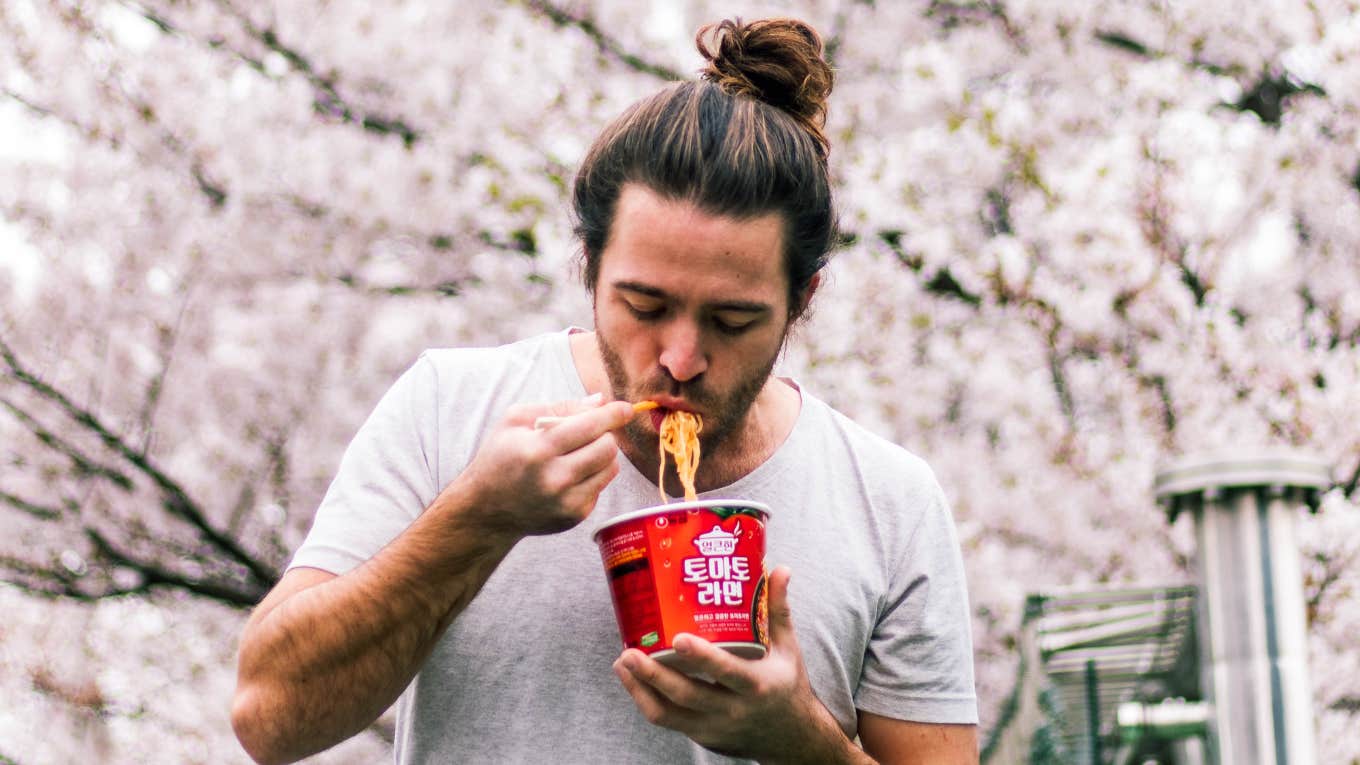 Man eating instant ramen