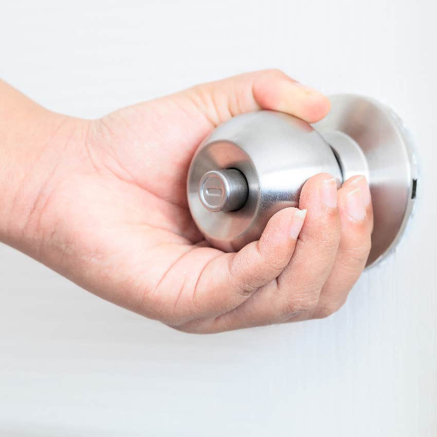 Man opening bathroom door