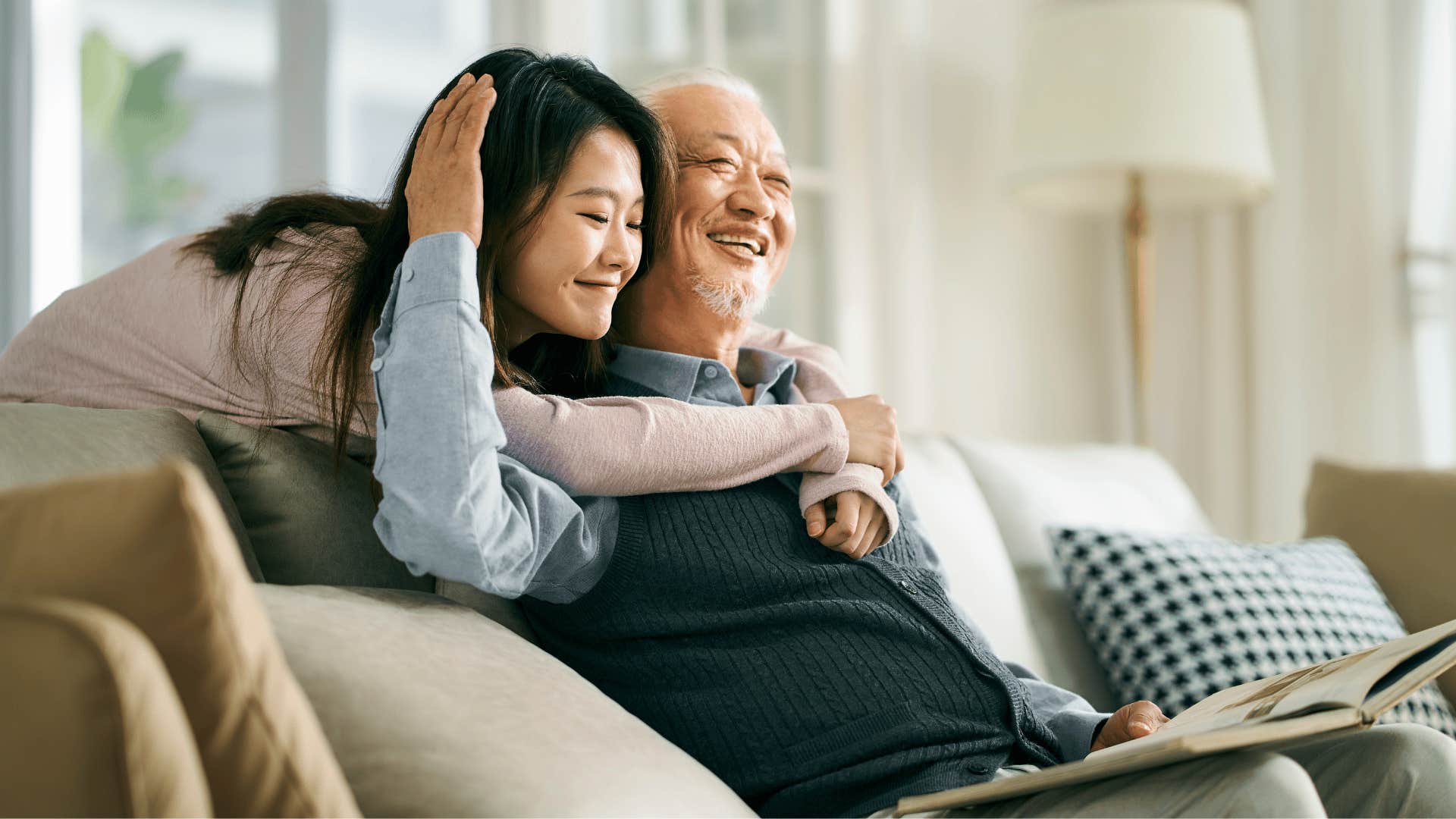 grown daughter hugging older father