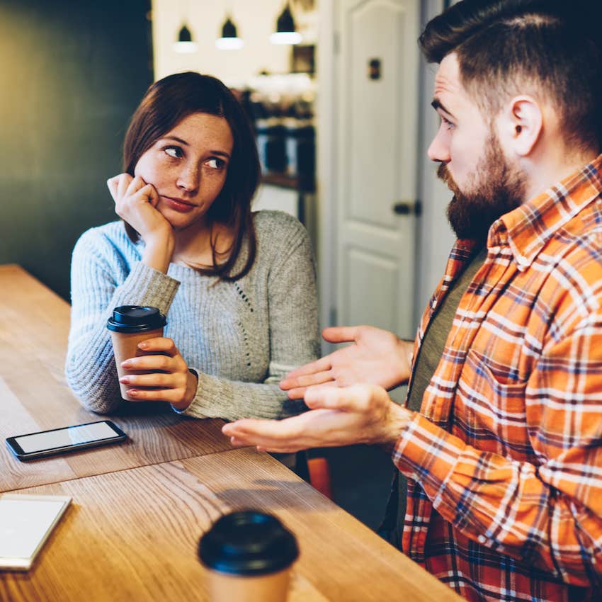 Couple in kitchen, their hand gestures indicate disagreement