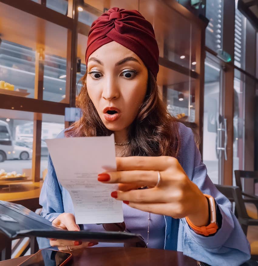 She is shocked by the tab at the restaurant