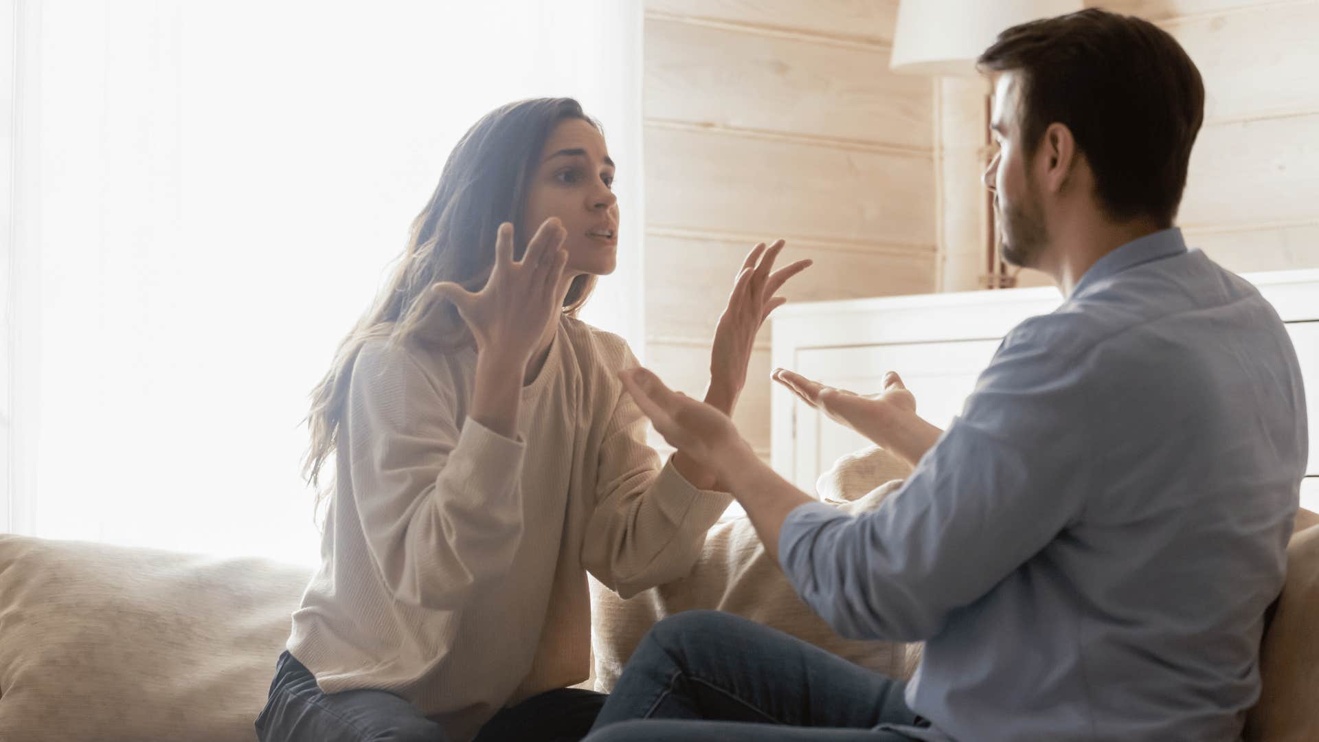 couple arguing on bed 