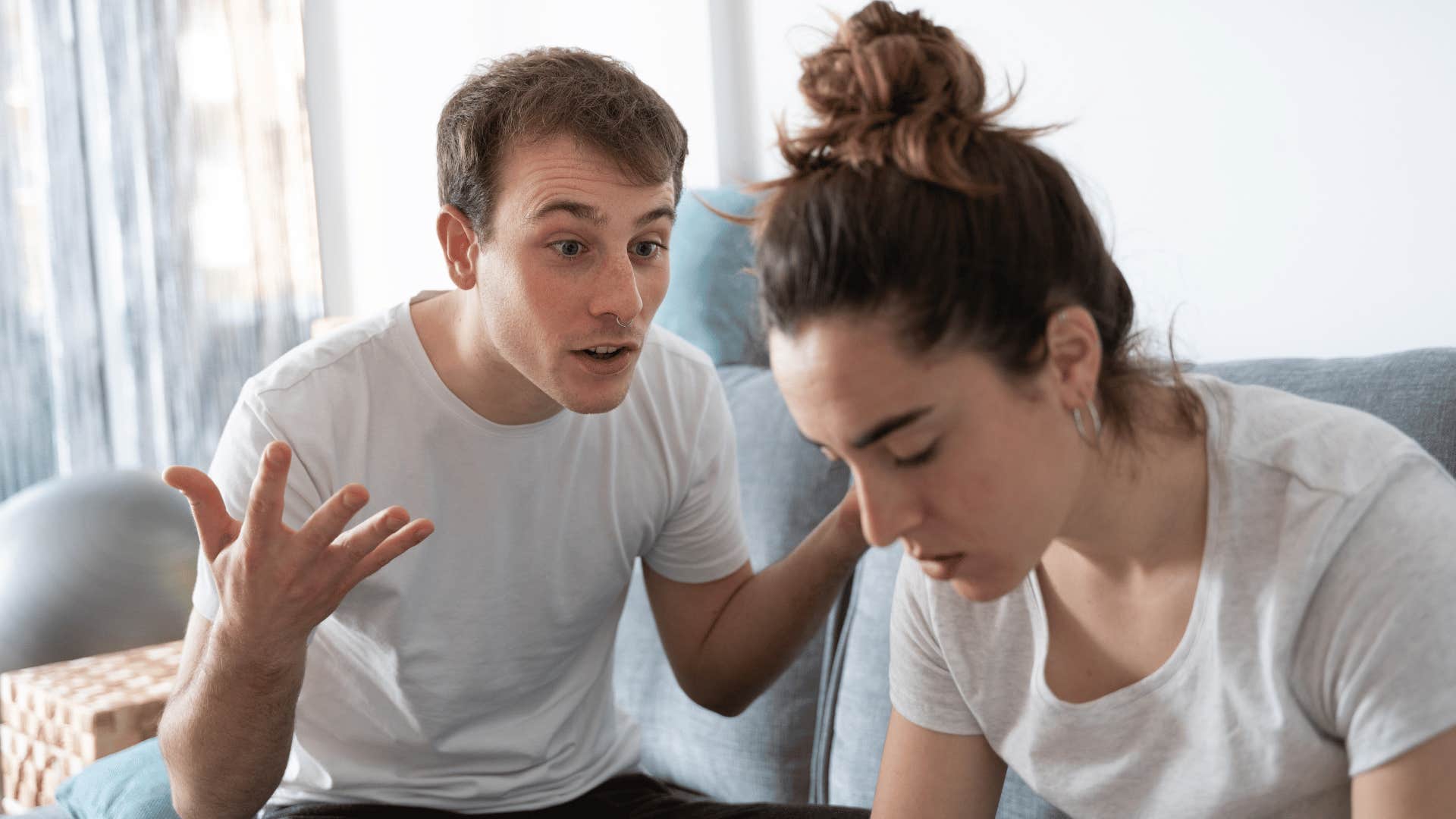 man yelling at woman while she puts her head down