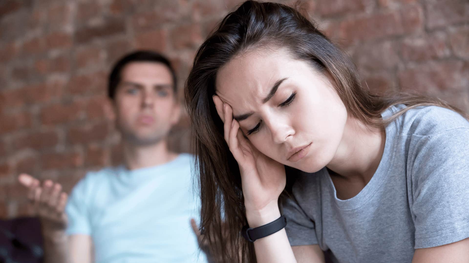 man yelling at woman while she looks overwhelmed