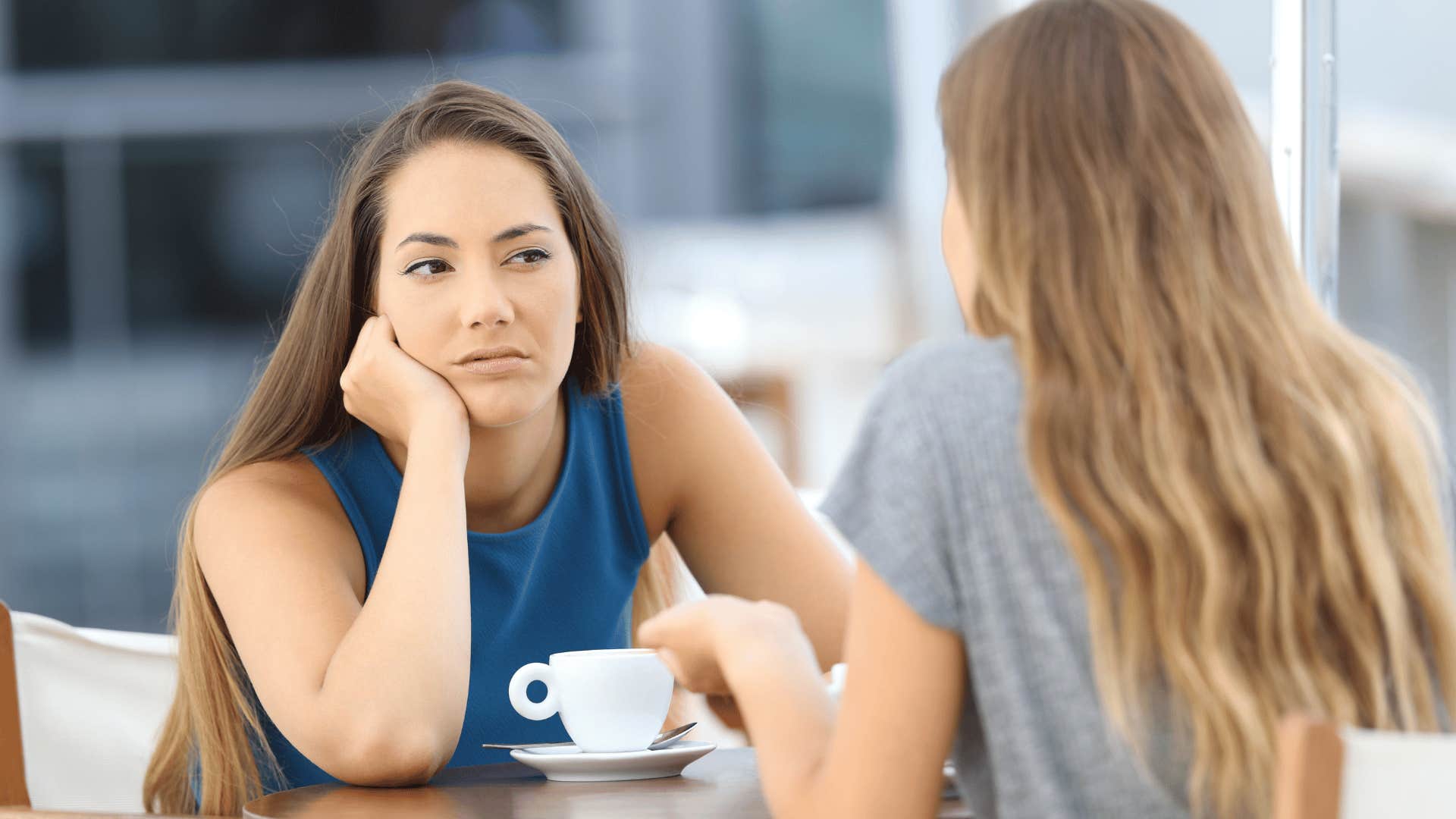 woman looking bored while friend talks 