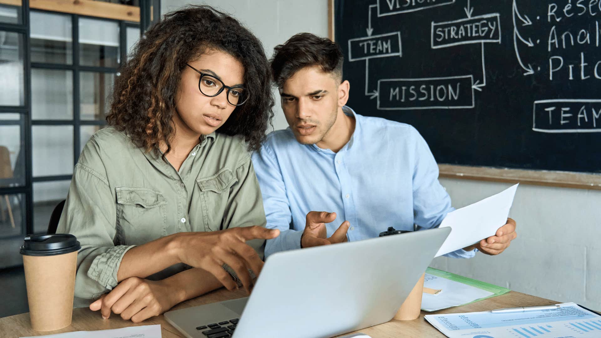 man and woman looking at laptop together 