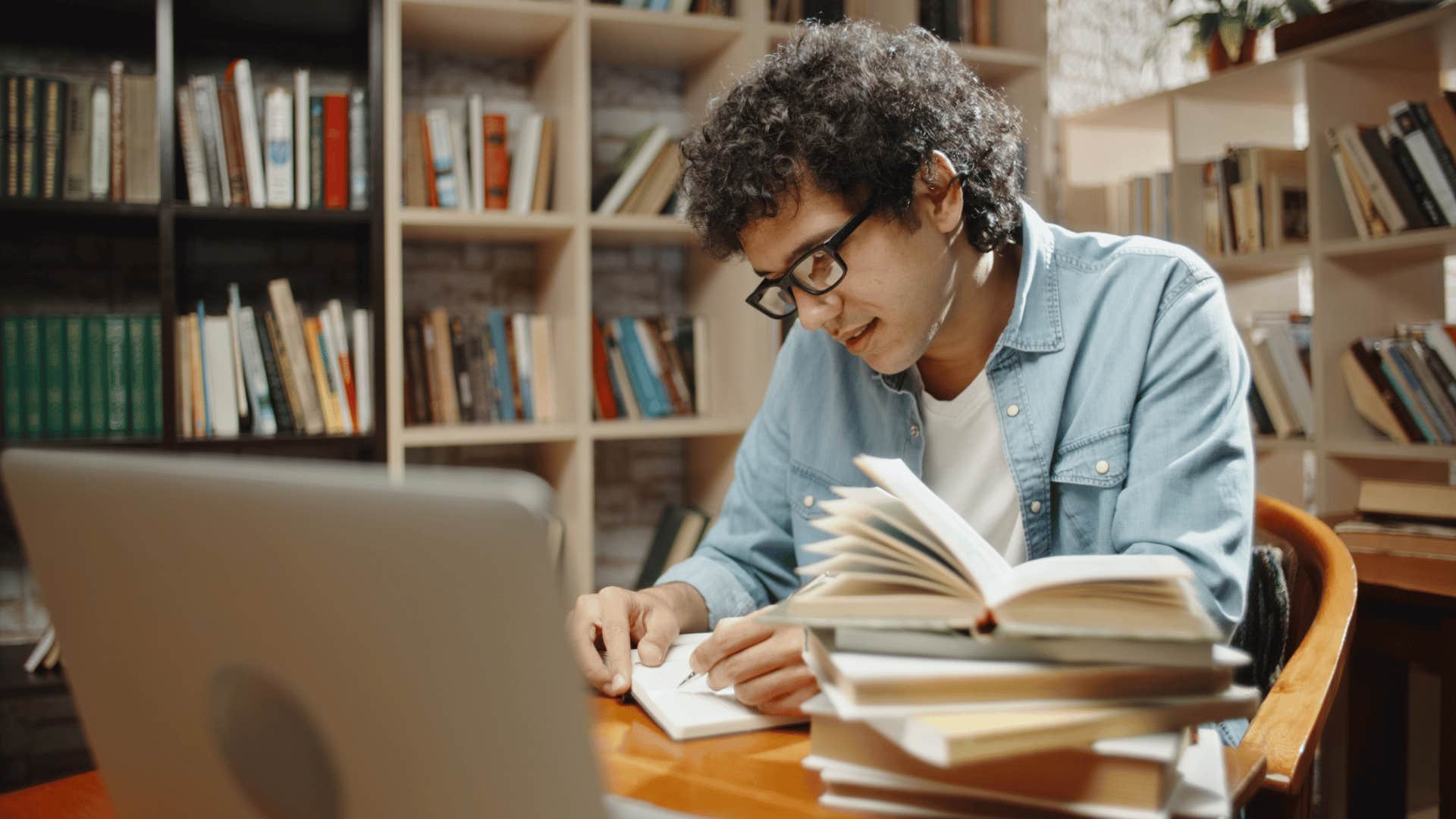 man researching in library 