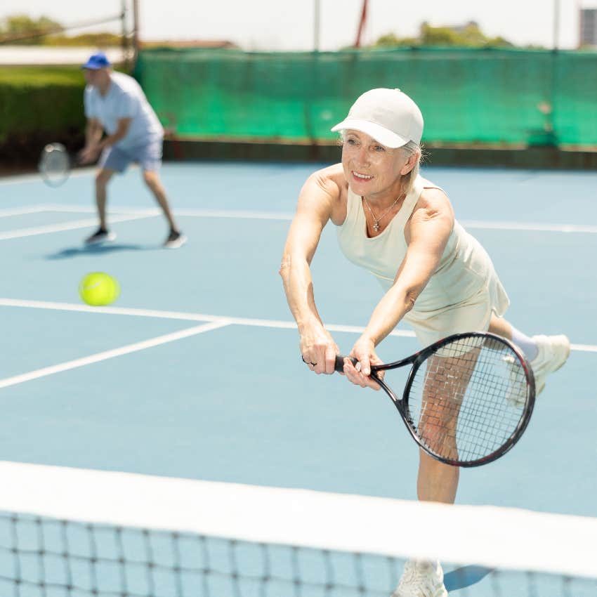 Older couple playing tennis to live longer