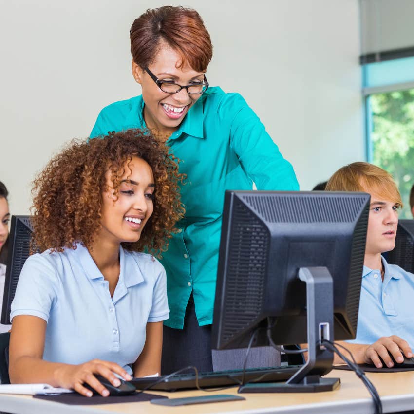 Private school student working with teacher on computer.