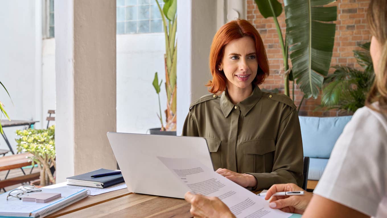 businesswoman talking to coworker in office