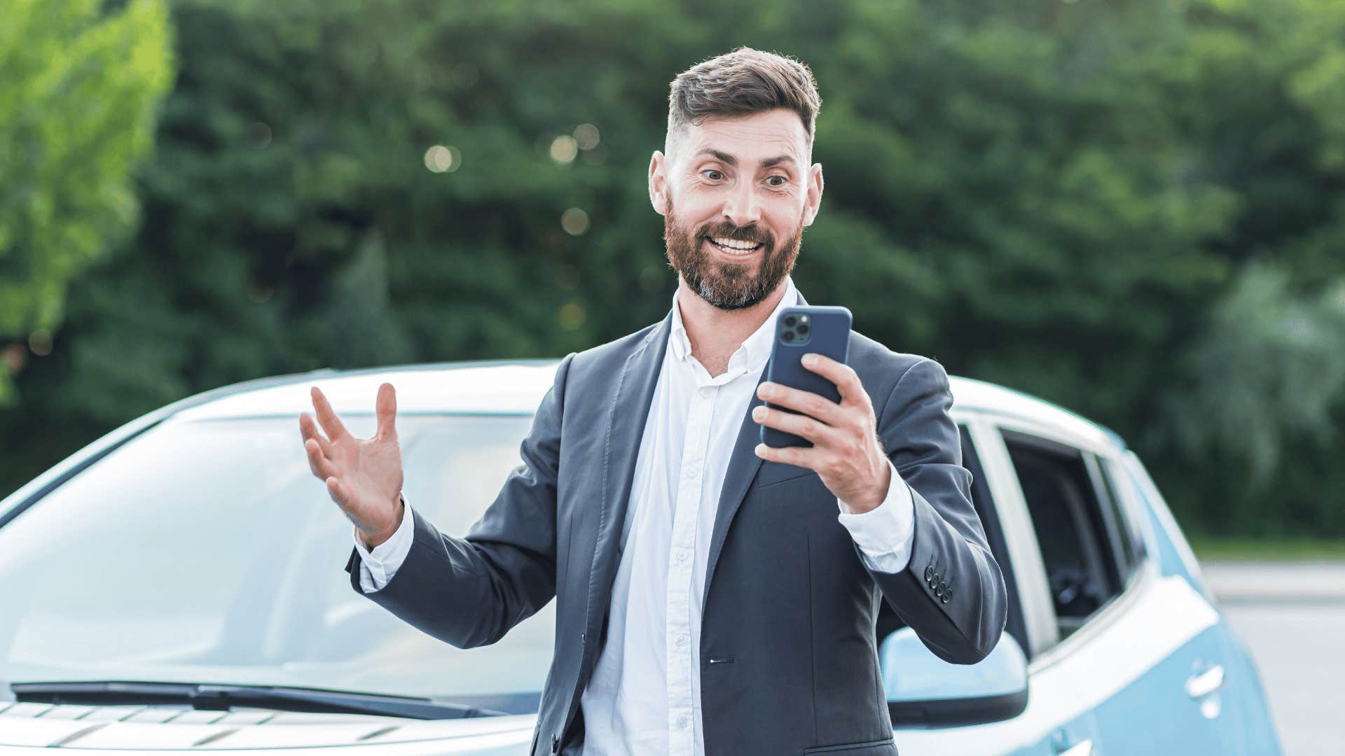 man facetiming while showing off car