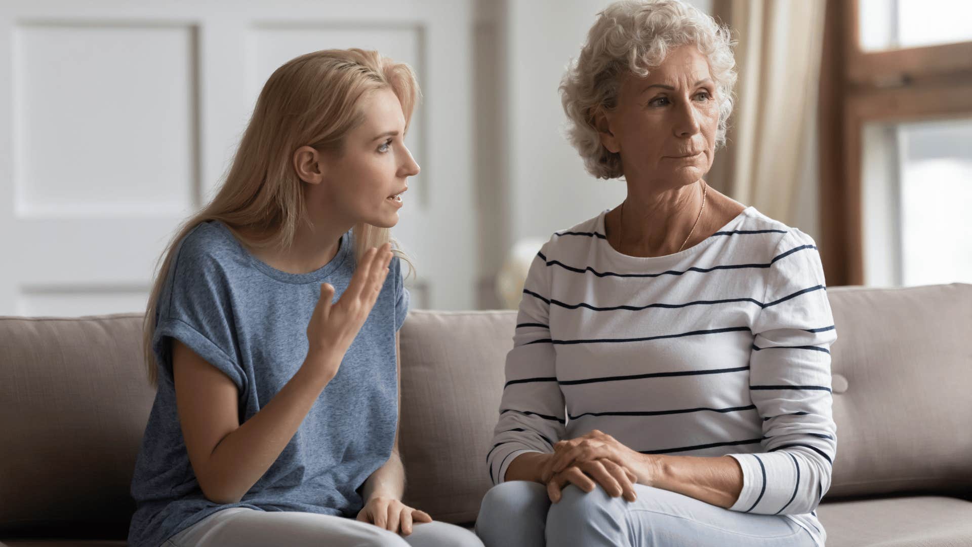 woman complaining to older woman while older woman isn't paying attention