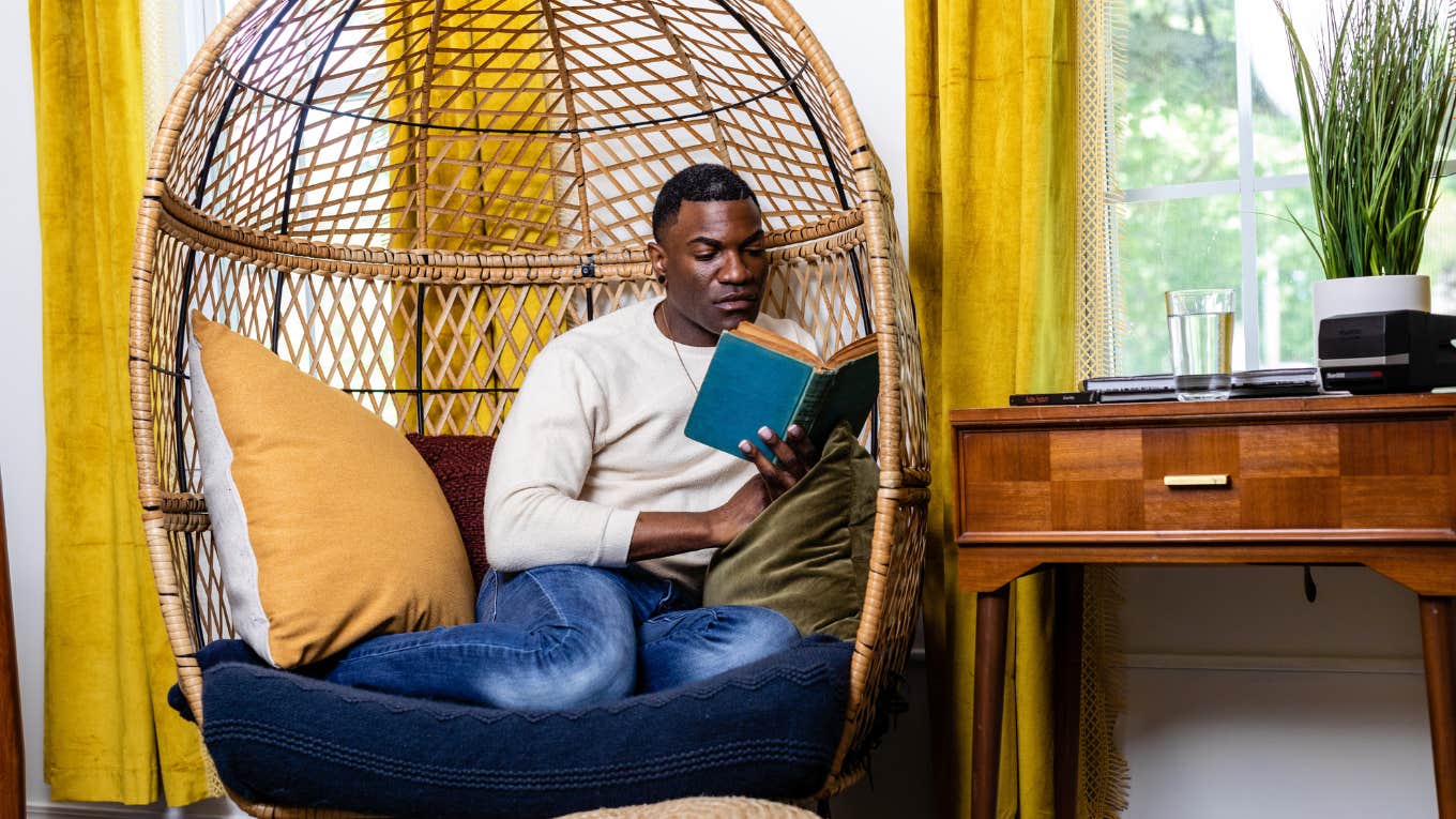 man reading in cozy nook