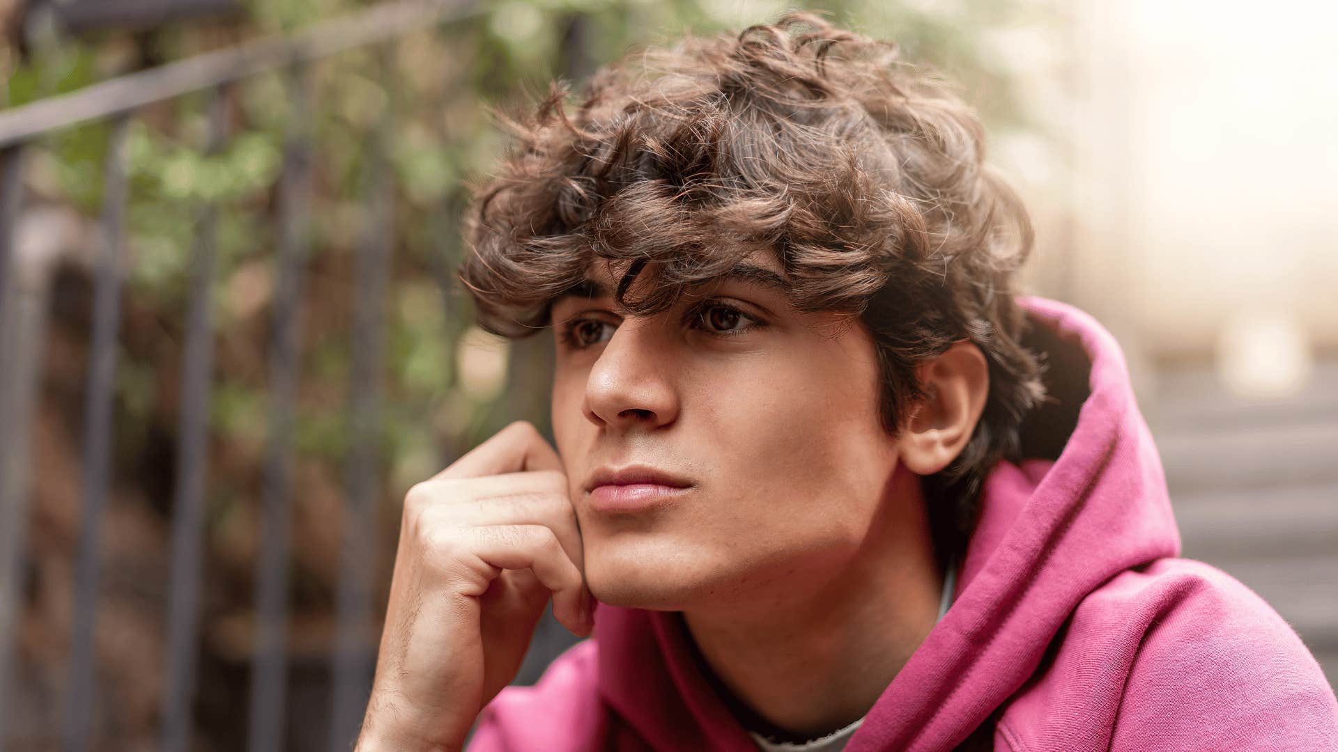 teen boy sitting alone