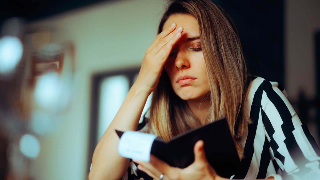 Unhappy Woman Receiving an Overpriced Bill in a Restaurant