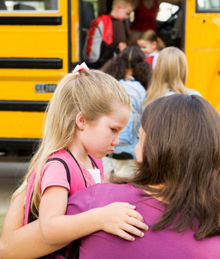 little girl with mom waiting for bus